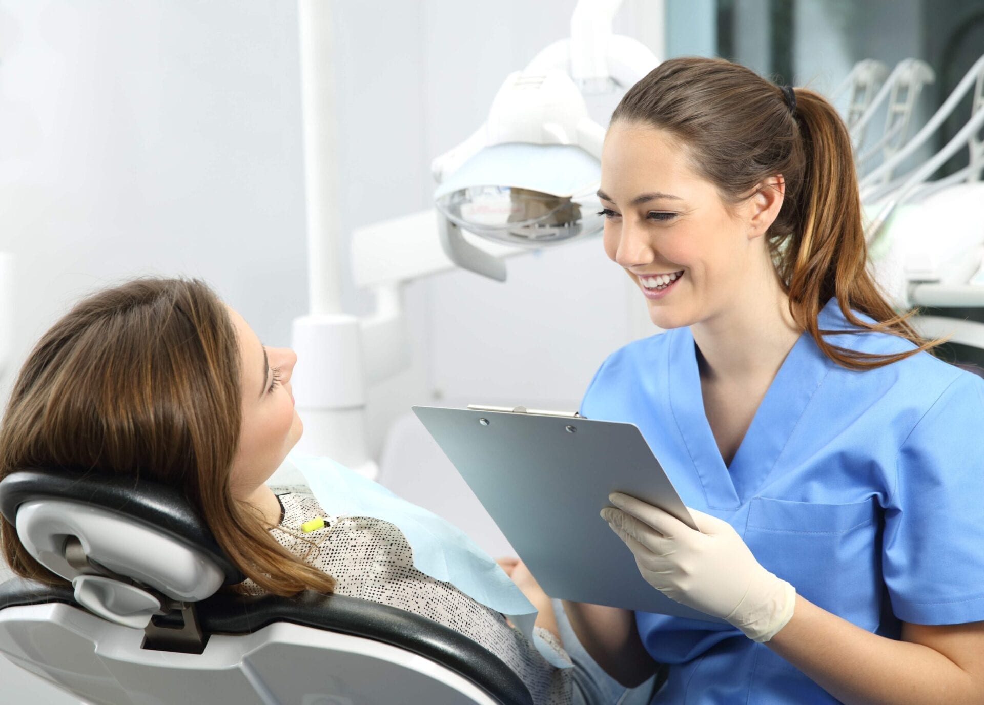 Dentist with medical history asking to a patient Dentist with medical
